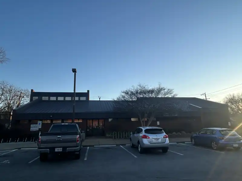 Commercial parking lot with trucks parked along a concrete curb
