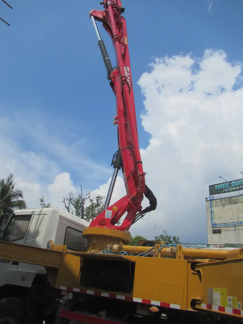 Concrete pump boom extended over a construction site