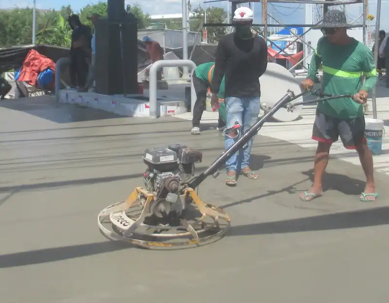 Finishers working a fresh slab with power trowels