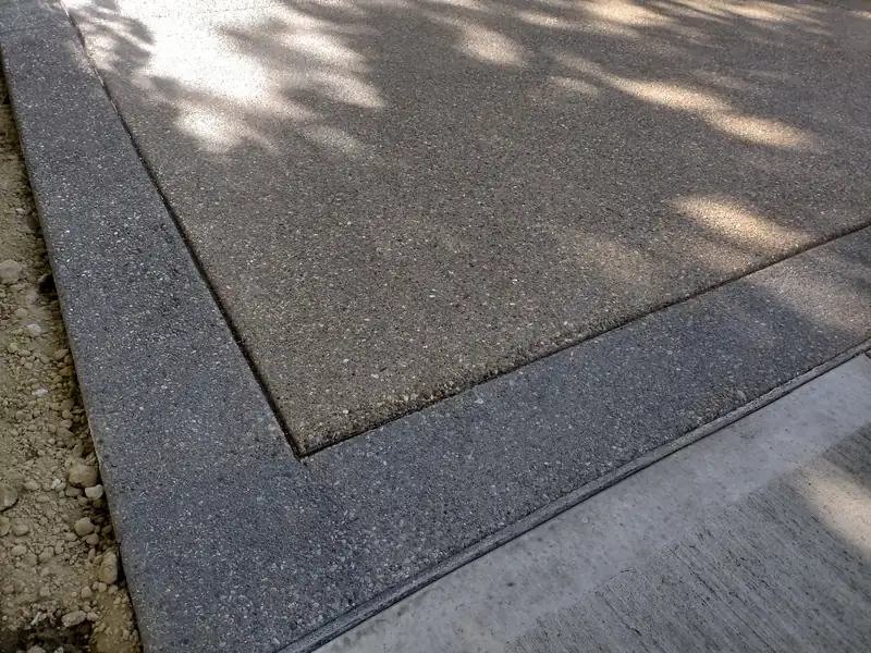 Weathered concrete slab with exposed stone and a worn top layer